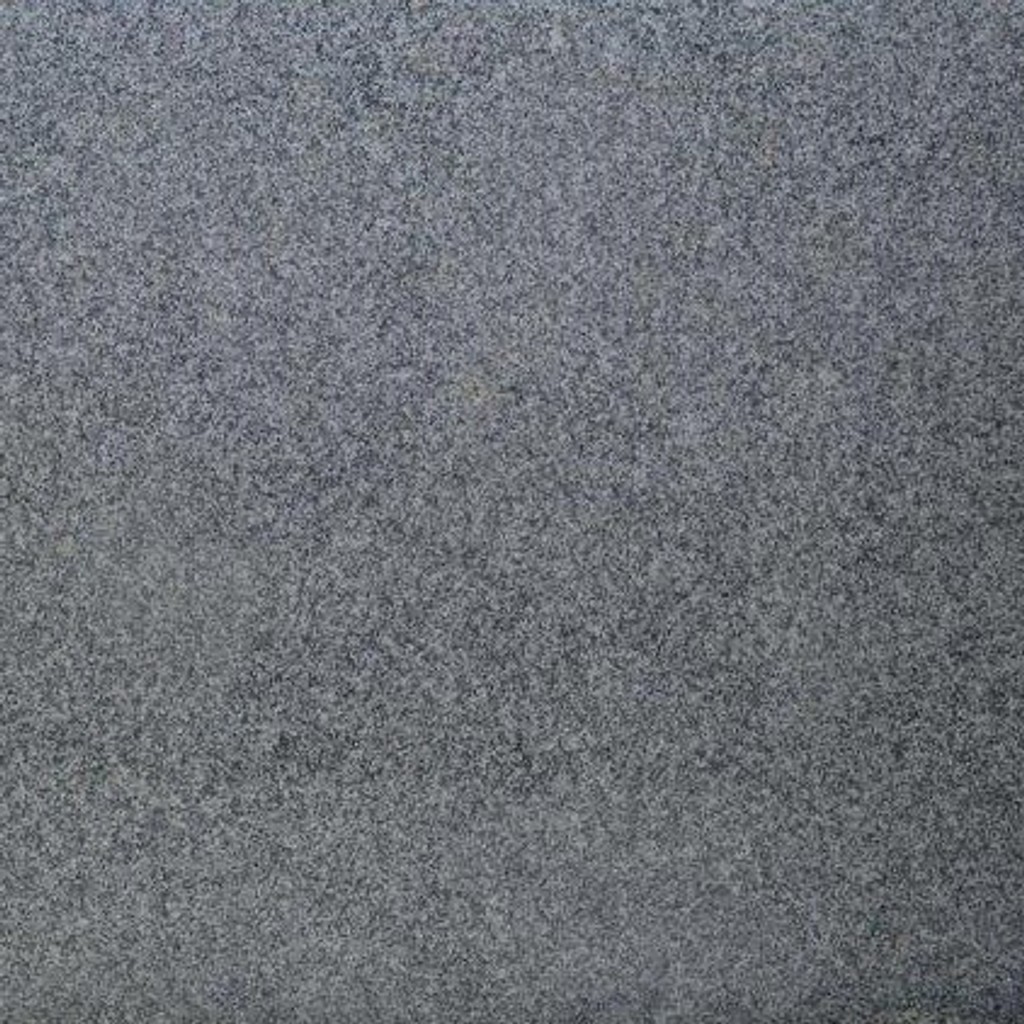 a Luna Pearl granite countertop surface that features pattern of white, black, gray, brown, and cream small speckles