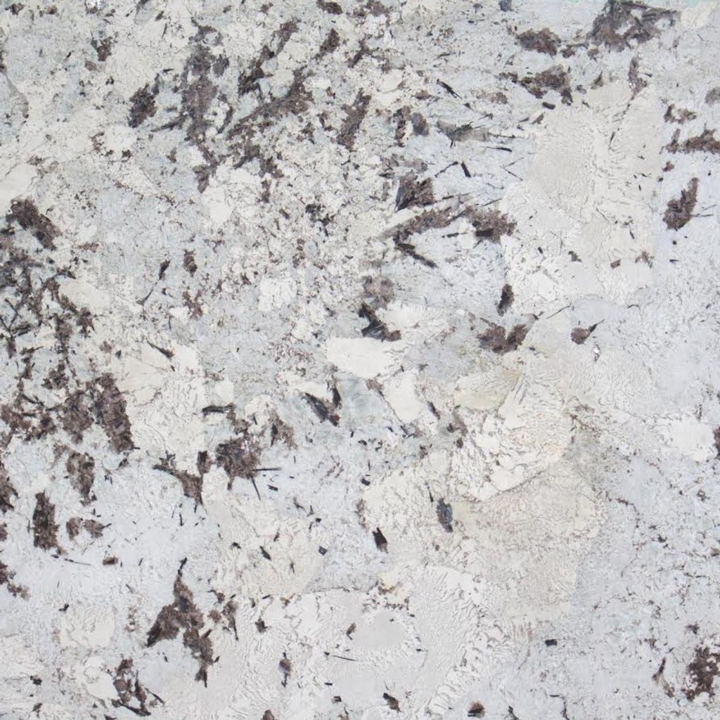 an Everest granite countertop surface that features splashes and spots of dark brown and tan over the off-white background