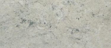 a Colonial White granite countertop surface that has gray details with black speckles over the creamy white background