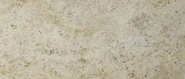 a Colonial Gold granite countertop surface that features brown, gray, and gold veins and flecks details over the creamy gray background