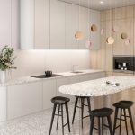 a modern kitchen with white top and bottom cabinets with round corners Vail Village Quartz countertops and kitchen island paired with black stool chairs against the wooden cabinetry and Vail Village Quartz flooring