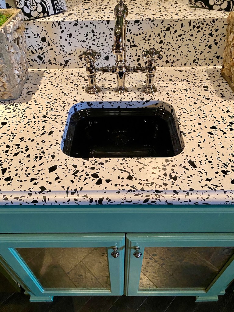 606427cbf2ded7f3177e78d5_IMG_0147 a sink over the Vail Village Quartz countertop above the turquoise cabinet base with silver hardware