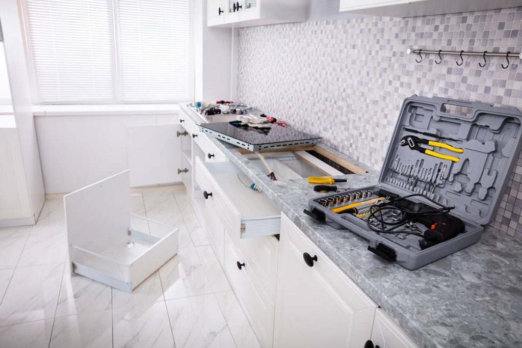 process and tools for stainless steel sink installation on the gray countertop