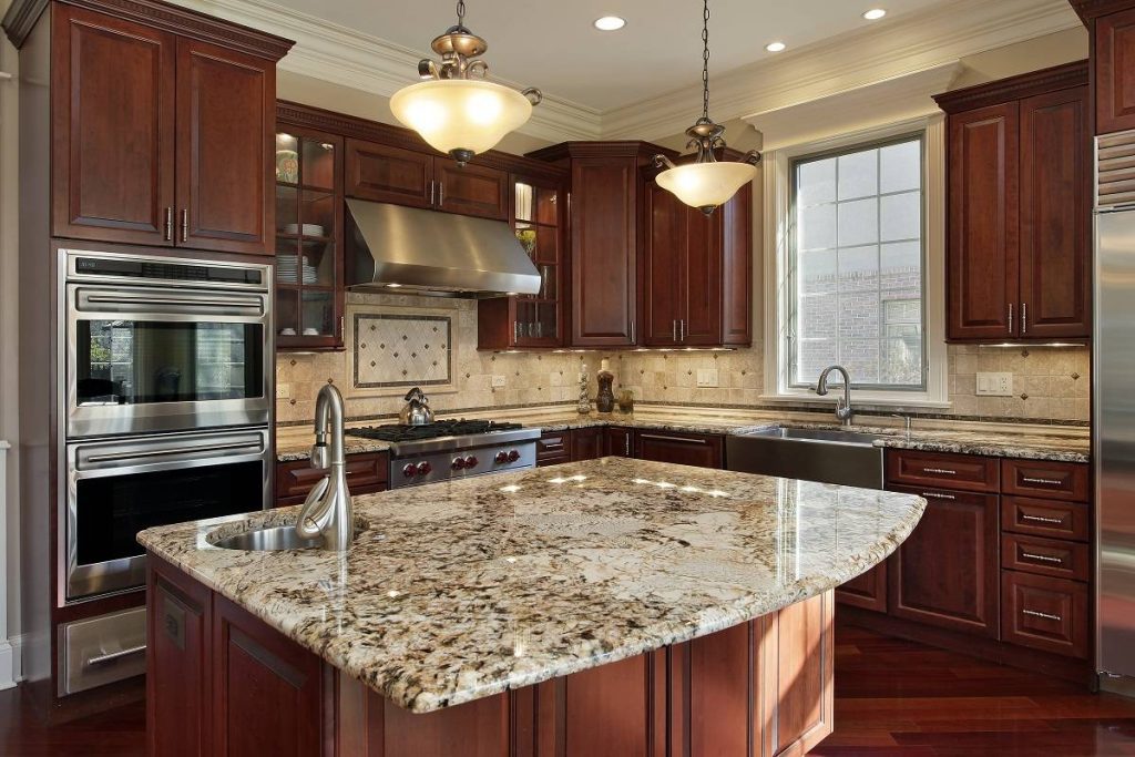 a kitchen with dark wood cabinetry and flooring, beige countertop and walls, and stainless steel appliances