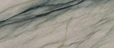 Audacia stone surface that blends veining of beiges, greens, charcoal, and black with the beige background