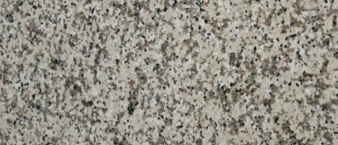 Crema-caramel stone pattern that blends flecks of gray, black, and brown on a creamy beige base