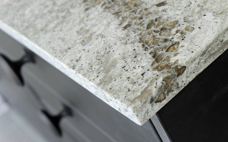 a neutral color ivory-white granite edge with flecks of black, beige, and gold accents all over the surface