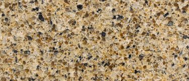 a scapolite quartz countertop surface that mixes granules of varying shades of warm colors
