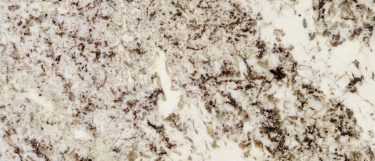 a white bahamas granite countertop surface with warm gray and beige tones accented by black specks
