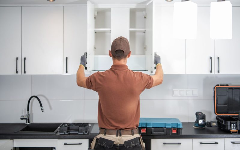 Modern White Kitchen Cabinets Installation Finished by Professional Cabinetmaker in His 40s. Furnishing Home Kitchen Theme.